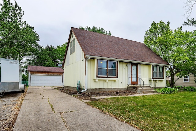 2209 8th Street Ct SW, Altoona, IA 50009 - view of front of property with a shingled roof, a detached garage, a front lawn, and board and batten siding