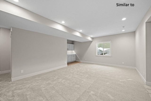 2228 Green Leaf Cir, Norwalk, IA 50211 - below grade area featuring light colored carpet, recessed lighting, and baseboards