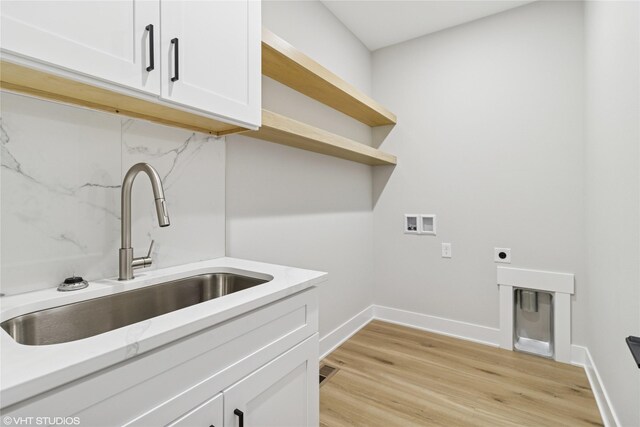 17400 Springbrook Trl, Urbandale, IA 50111 - laundry room with cabinet space, hookup for a washing machine, light wood finished floors, baseboards, and hookup for an electric dryer