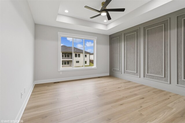 17400 Springbrook Trl, Urbandale, IA 50111 - unfurnished bedroom featuring a tray ceiling, light wood-style floors, baseboards, recessed lighting, and a ceiling fan
