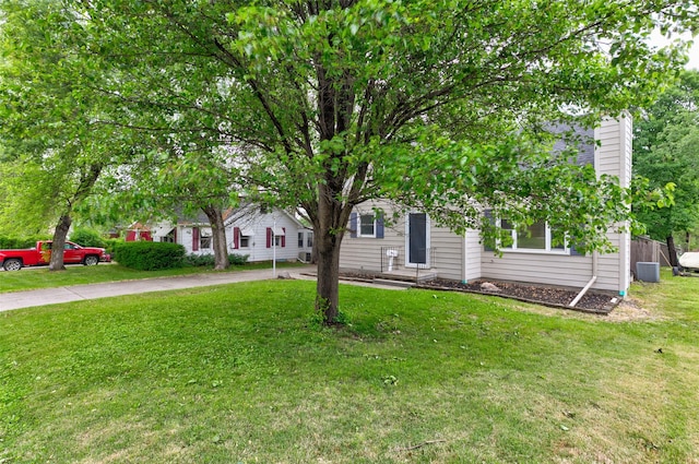 4007 68th St, Urbandale, IA 50322 - obstructed view of property with a front lawn and central AC