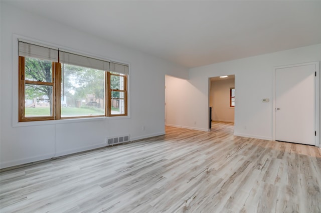 4007 68th St, Urbandale, IA 50322 - empty room featuring light wood-style flooring and healthy amount of natural light