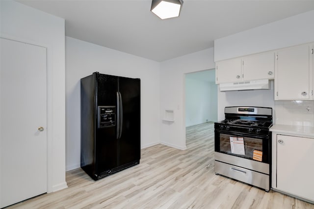 4007 68th St, Urbandale, IA 50322 - kitchen featuring black fridge with ice dispenser, stainless steel gas stove, under cabinet range hood, and light wood-style flooring