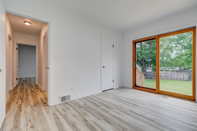4007 68th St, Urbandale, IA 50322 - unfurnished bedroom featuring access to outside, light wood-style flooring, and baseboards