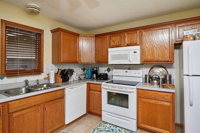 1236 63rd St, Windsor Heights, IA 50324 - kitchen featuring white appliances, a sink, tasteful backsplash, and light countertops