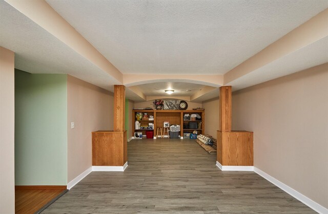 1236 63rd St, Windsor Heights, IA 50324 - bar with arched walkways, baseboards, and wood finished floors