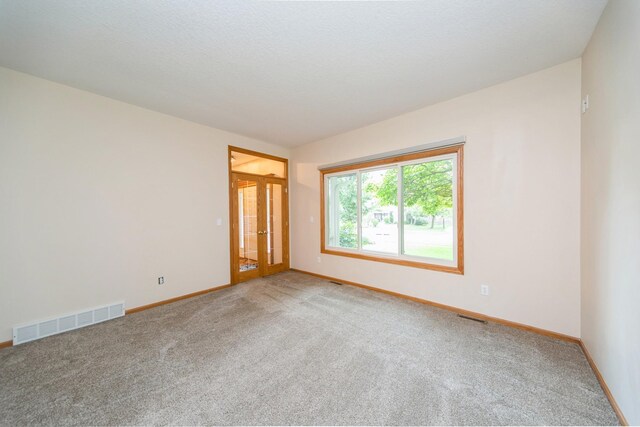 2230 NW 138th St, Clive, IA 50325 - empty room with carpet, french doors, and baseboards