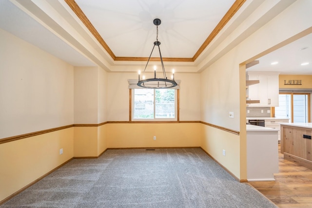 2230 NW 138th St, Clive, IA 50325 - unfurnished room featuring ornamental molding, plenty of natural light, a raised ceiling, a chandelier, and baseboards