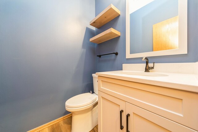2230 NW 138th St, Clive, IA 50325 - half bath with wood finished floors, toilet, and vanity