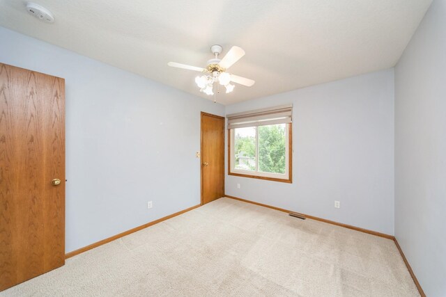 2230 NW 138th St, Clive, IA 50325 - spare room with carpet floors, baseboards, a smoke detector, and a ceiling fan