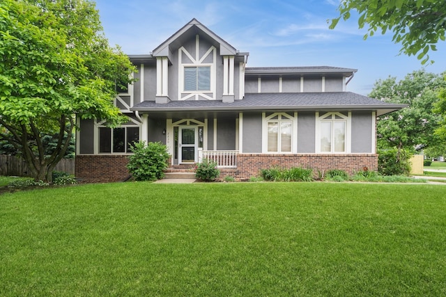 2230 NW 138th St, Clive, IA 50325 - tudor home with stucco siding, a front lawn, brick siding, and a porch