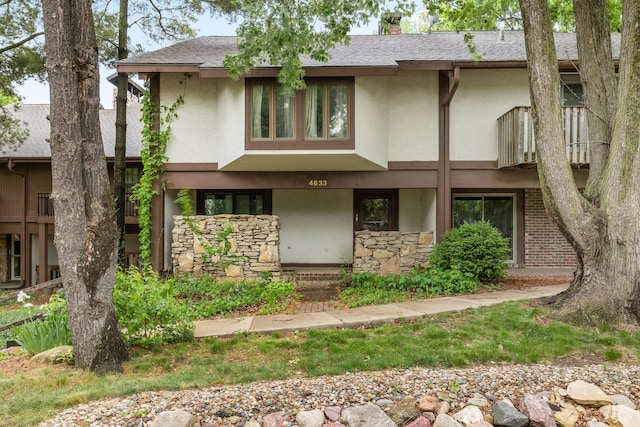 4633 Lockner Dr Unit 3, Urbandale, IA 50322 - view of front facade featuring stucco siding, stone siding, a chimney, and roof with shingles