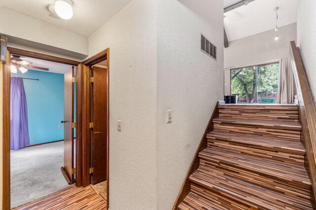 4633 Lockner Dr Unit 3, Urbandale, IA 50322 - stairway featuring lofted ceiling and a ceiling fan