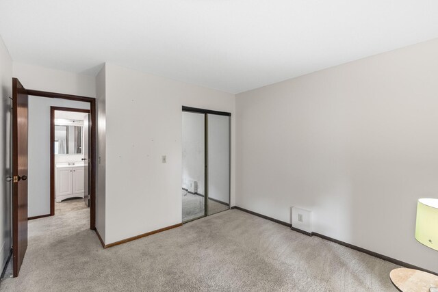 4633 Lockner Dr Unit 3, Urbandale, IA 50322 - unfurnished bedroom with light carpet, a closet, and baseboards