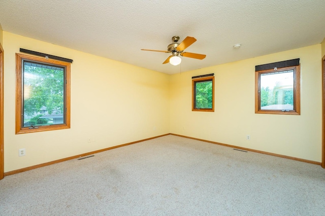 4521 77th St, Urbandale, IA 50322 - carpeted empty room featuring ceiling fan, baseboards, and a textured ceiling