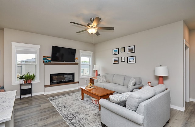 1917 Southbridge Dr, Adel, IA 50003 - living area with a ceiling fan, light wood finished floors, and a glass covered fireplace
