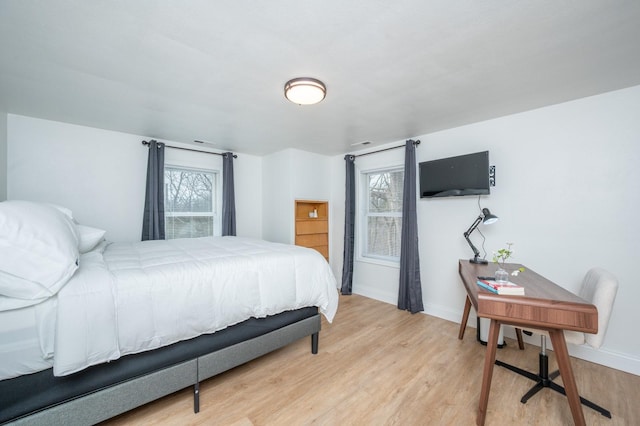 211 Park Ave, Des Moines, IA 50315 - bedroom featuring light wood-type flooring, baseboards, and an office area