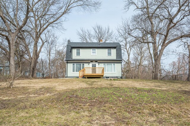 211 Park Ave, Des Moines, IA 50315 - rear view of house with a wooden deck, a yard, a chimney, and a shingled roof