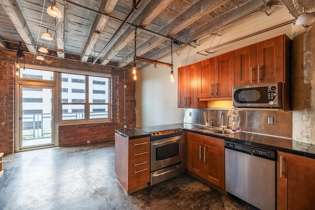 112 11th St Unit 506, Des Moines, IA 50309 - kitchen featuring appliances with stainless steel finishes, concrete flooring, a peninsula, a sink, and brown cabinetry