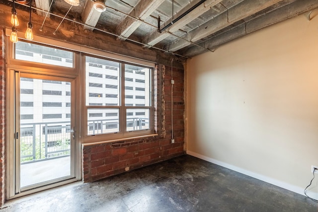 112 11th St Unit 506, Des Moines, IA 50309 - unfurnished room with concrete floors, healthy amount of natural light, and baseboards