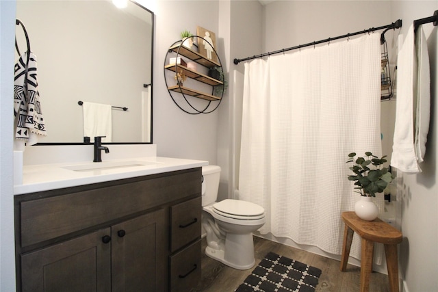 5015 153rd St, Urbandale, IA 50323 - full bath featuring wood finished floors, toilet, vanity, and a shower with shower curtain