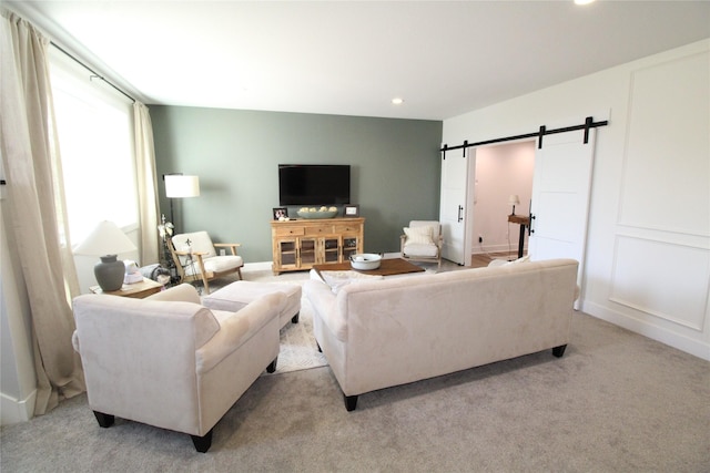 5015 153rd St, Urbandale, IA 50323 - living area featuring a barn door, recessed lighting, and light colored carpet
