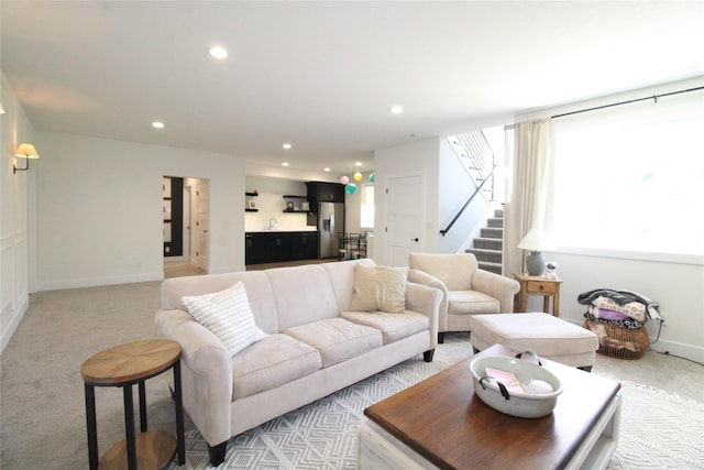 5015 153rd St, Urbandale, IA 50323 - living room with stairs, light colored carpet, recessed lighting, and baseboards
