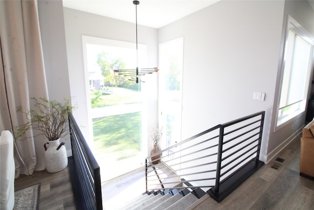 5015 153rd St, Urbandale, IA 50323 - stairway featuring wood finished floors and a chandelier