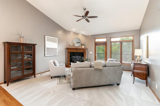 3605 151st St, Urbandale, IA 50323 - living room featuring ceiling fan, baseboards, a glass covered fireplace, and high vaulted ceiling