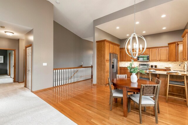3605 151st St, Urbandale, IA 50323 - dining room with a chandelier, light wood-style flooring, baseboards, and recessed lighting