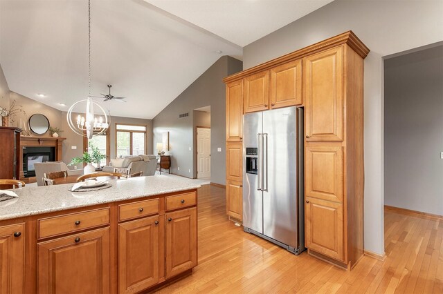 3605 151st St, Urbandale, IA 50323 - kitchen featuring high end fridge, open floor plan, a chandelier, light wood-style flooring, and lofted ceiling