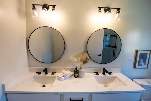 712 63rd St, West Des Moines, IA 50266 - bathroom featuring double vanity and toilet