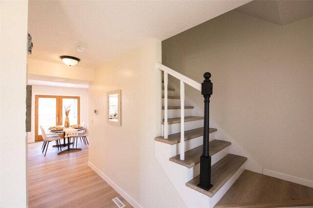 712 63rd St, West Des Moines, IA 50266 - stairway featuring wood finished floors and baseboards