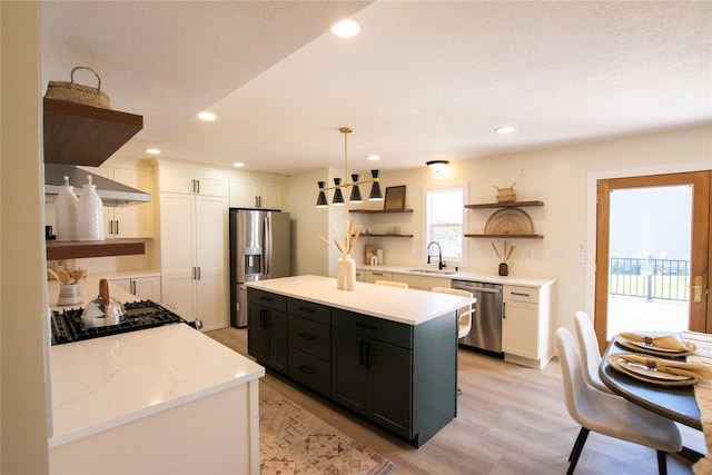 712 63rd St, West Des Moines, IA 50266 - kitchen with open shelves, appliances with stainless steel finishes, dark cabinets, white cabinetry, and light wood-type flooring