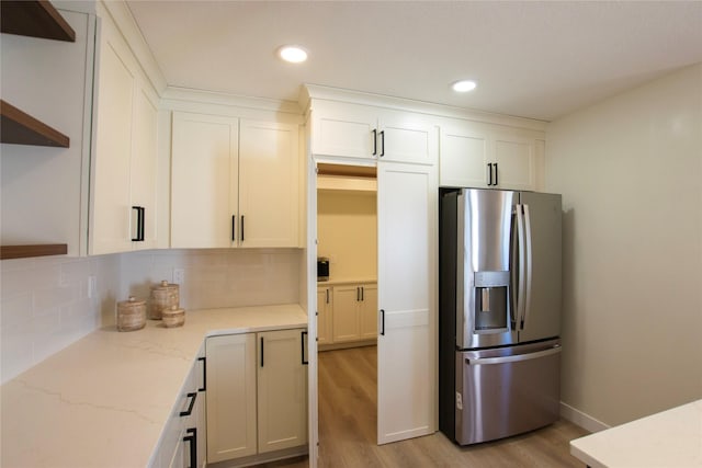 712 63rd St, West Des Moines, IA 50266 - kitchen with stainless steel fridge, open shelves, light wood-style flooring, white cabinets, and recessed lighting