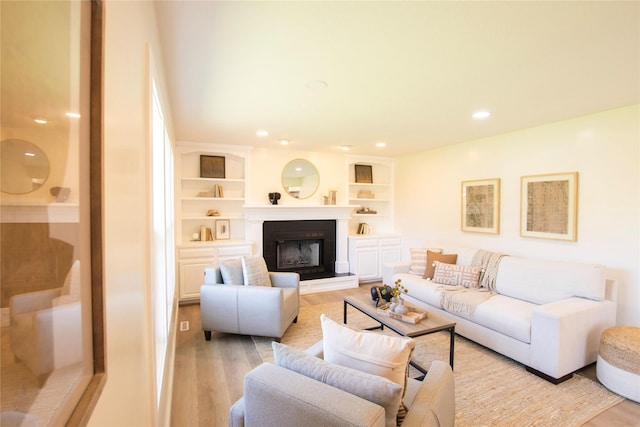 712 63rd St, West Des Moines, IA 50266 - living room with light wood-type flooring, recessed lighting, and a fireplace with raised hearth