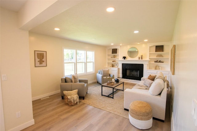 712 63rd St, West Des Moines, IA 50266 - living room with recessed lighting, baseboards, a fireplace, and light wood finished floors
