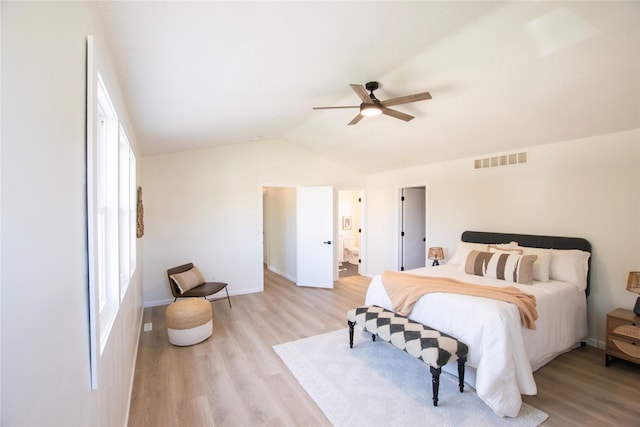 712 63rd St, West Des Moines, IA 50266 - bedroom featuring light wood-style floors, lofted ceiling, baseboards, a ceiling fan, and ensuite bathroom