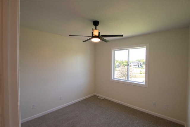 712 63rd St, West Des Moines, IA 50266 - empty room featuring a ceiling fan, dark colored carpet, and baseboards