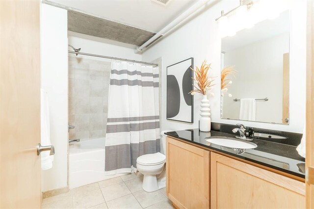 119 4th St Unit 102, Des Moines, IA 50309 - bathroom featuring toilet, tile patterned floors, vanity, and shower / bath combo