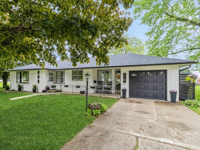 803 2nd St, Sully, IA 50251 - single story home with covered porch, an attached garage, a front lawn, concrete driveway, and a shingled roof
