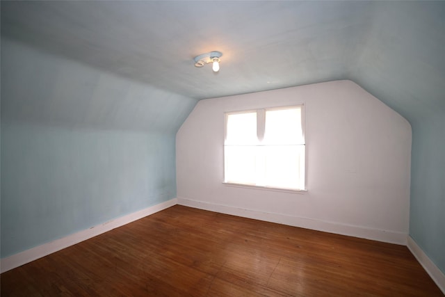 109 Greene St, Boone, IA 50036 - additional living space with lofted ceiling, dark wood-type flooring, and baseboards