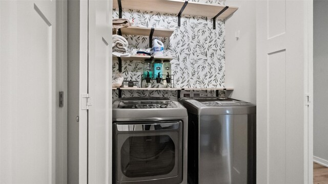 812 Juniper St NW, Bondurant, IA 50035 - laundry area with washer and clothes dryer and wood finished floors