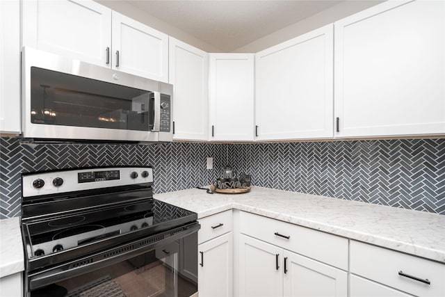 406 SE Trilein Dr, Ankeny, IA 50021 - kitchen featuring electric range, stainless steel microwave, and white cabinetry