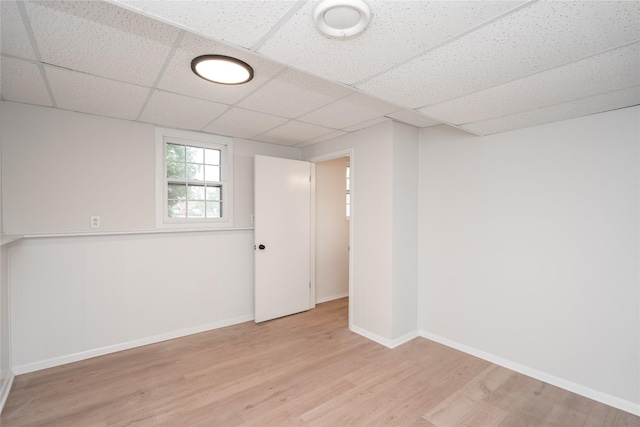 406 SE Trilein Dr, Ankeny, IA 50021 - below grade area featuring light wood-type flooring, baseboards, and a paneled ceiling