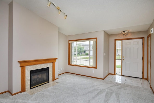 6200 Ep True Pkwy Unit 601, West Des Moines, IA 50266 - carpeted entrance foyer featuring baseboards, a tiled fireplace, rail lighting, and tile patterned flooring
