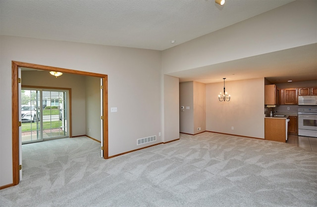 6200 Ep True Pkwy Unit 601, West Des Moines, IA 50266 - unfurnished living room featuring light carpet, a chandelier, and baseboards
