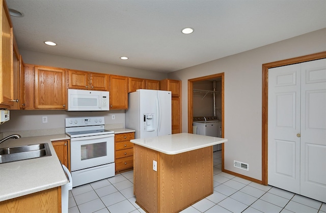 6200 Ep True Pkwy Unit 601, West Des Moines, IA 50266 - kitchen featuring white appliances, a sink, separate washer and dryer, light countertops, and recessed lighting
