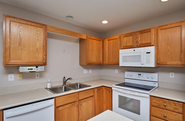 6200 Ep True Pkwy Unit 601, West Des Moines, IA 50266 - kitchen with white appliances, a sink, light countertops, recessed lighting, and brown cabinets