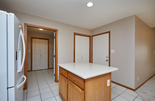6200 Ep True Pkwy Unit 601, West Des Moines, IA 50266 - kitchen featuring white refrigerator with ice dispenser, baseboards, light tile patterned floors, and light countertops